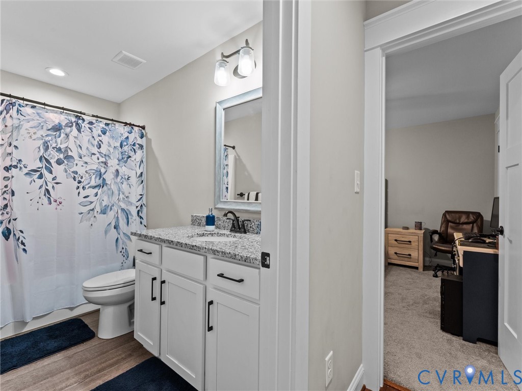 10819 Vaughan Road Petersburg, VA 23805 - Photo 36 of 45 Bathroom featuring a white vanity with dark hardwa