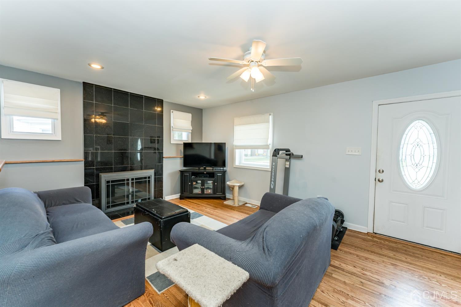 28 West Upper Ferry Road Ewing, NJ 08628 - Photo 2 of 19 a living room with furniture a fireplace and a flat screen tv