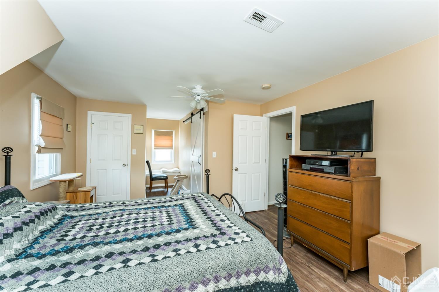28 West Upper Ferry Road Ewing, NJ 08628 - Photo 13 of 19 a bedroom with a bed and a flat screen tv