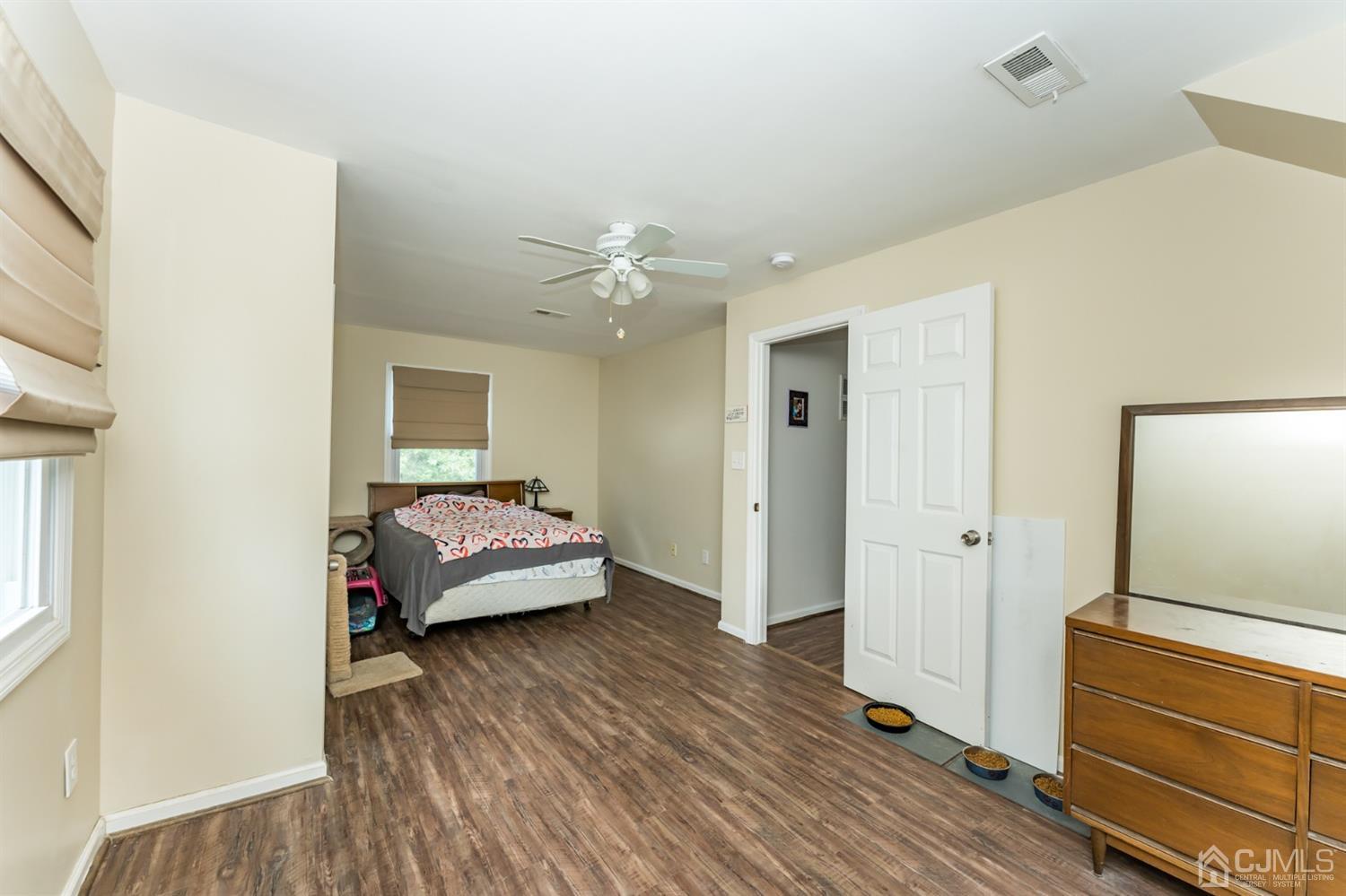 28 West Upper Ferry Road Ewing, NJ 08628 - Photo 14 of 19 a bedroom with a bed and wooden floor