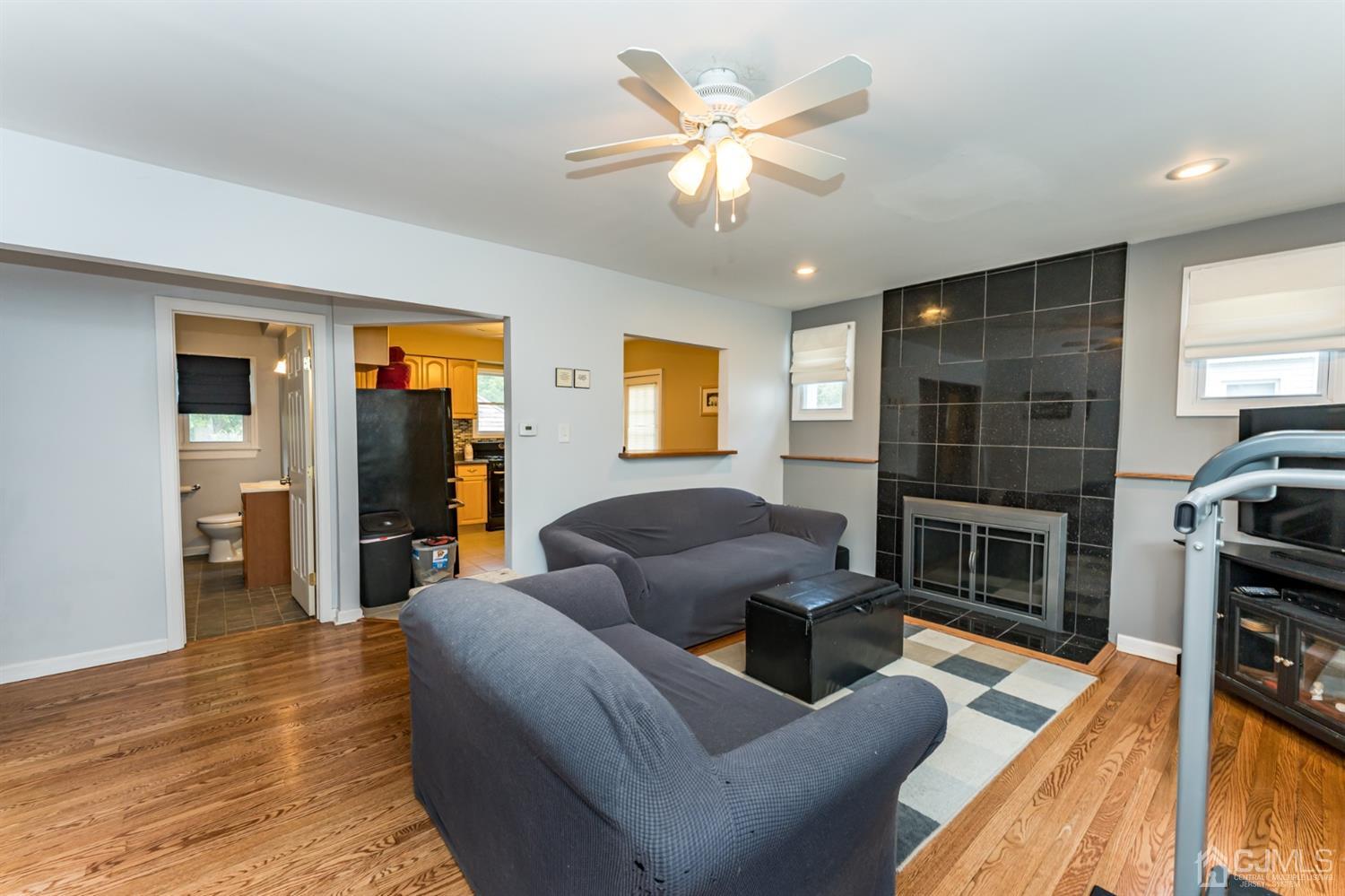 28 West Upper Ferry Road Ewing, NJ 08628 - Photo 4 of 19 a living room with furniture a fireplace and a flat screen tv