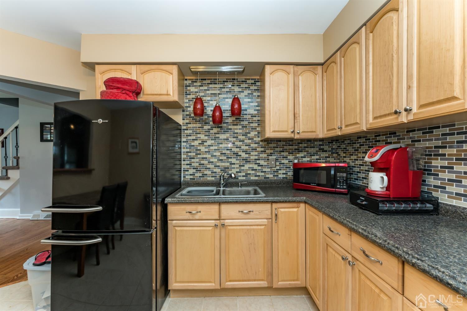 28 West Upper Ferry Road Ewing, NJ 08628 - Photo 7 of 19 a kitchen with stainless steel appliances granite countertop a stove and cabinets