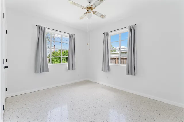 an empty room with windows and closet