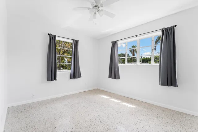 a bathroom with a bathtub shower sink vanity and toilet