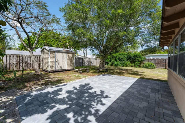a view of a house with a yard and potted plants