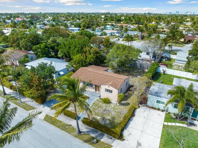 an aerial view of multiple houses with yard