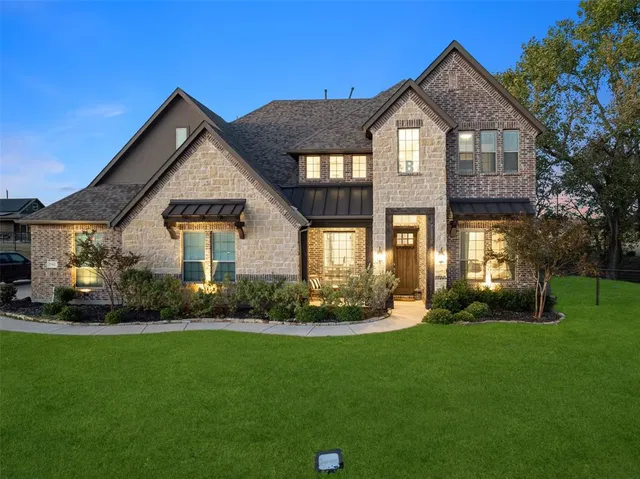 a front view of a house with a garden and plants