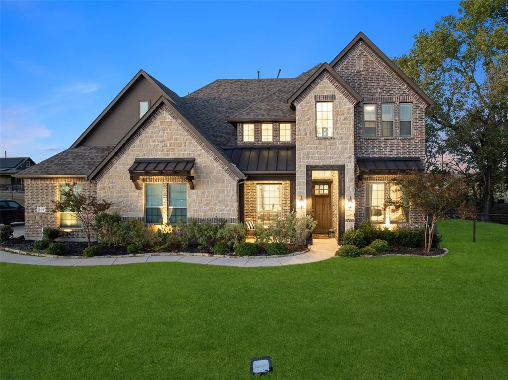 a front view of a house with a garden and plants