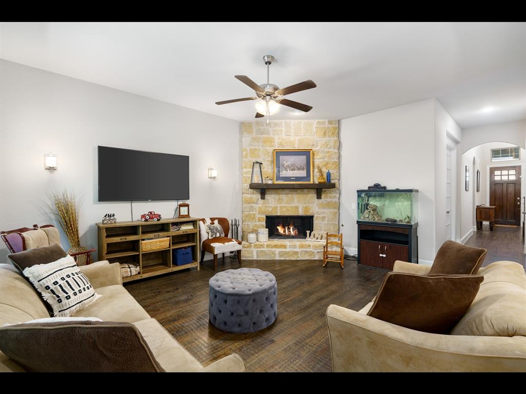 191 Daniel Drive Van Alstyne, TX 75495 - Photo 11 of 32 a living room with furniture a flat screen tv and a fireplace
