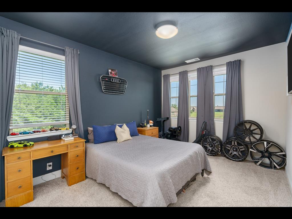 191 Daniel Drive Van Alstyne, TX 75495 - Photo 15 of 32 a bedroom with a bed and a large window