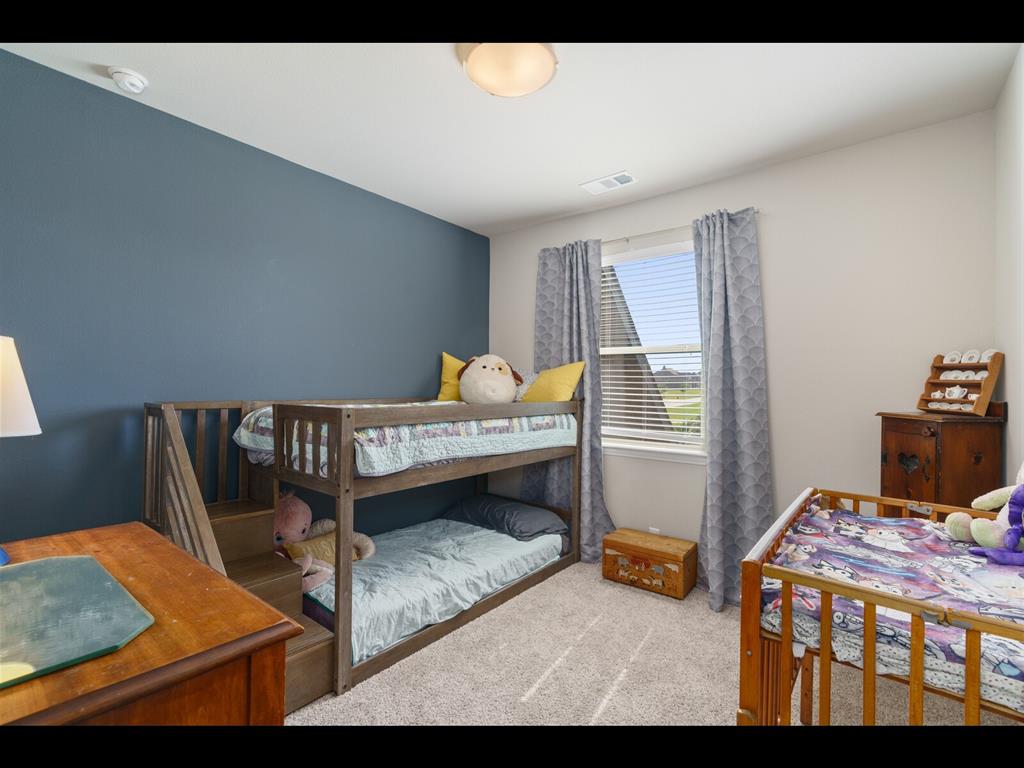 191 Daniel Drive Van Alstyne, TX 75495 - Photo 17 of 32 a bedroom with furniture and a bed