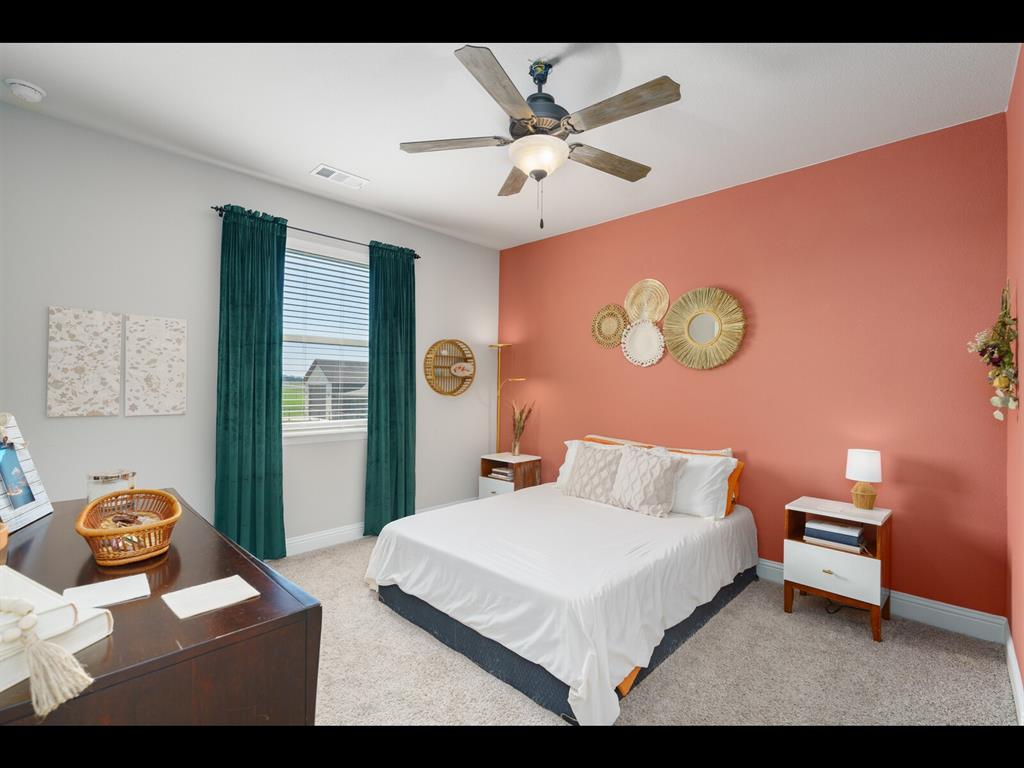 191 Daniel Drive Van Alstyne, TX 75495 - Photo 18 of 32 a bedroom with a bed and a chandelier