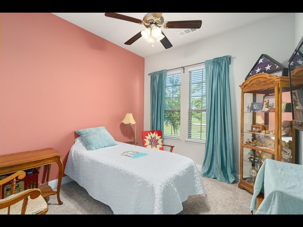 191 Daniel Drive Van Alstyne, TX 75495 - Photo 6 of 32 a bedroom with a bed and a chandelier