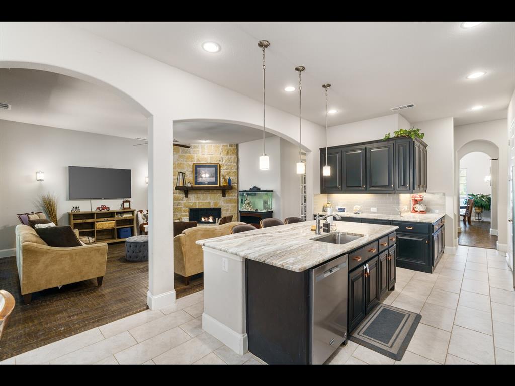 191 Daniel Drive Van Alstyne, TX 75495 - Photo 32 of 32 a large kitchen with cabinets a sink and a stove