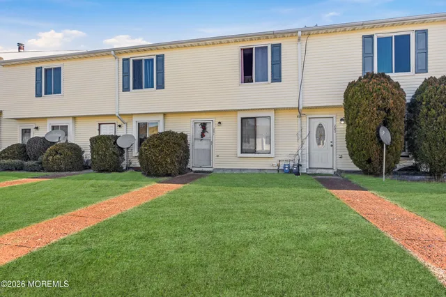 a view of a front of a house with a yard