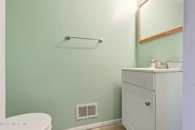 a bathroom with a sink a toilet and mirror