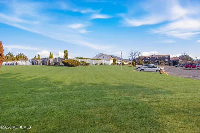 a view of a field with of cars parked