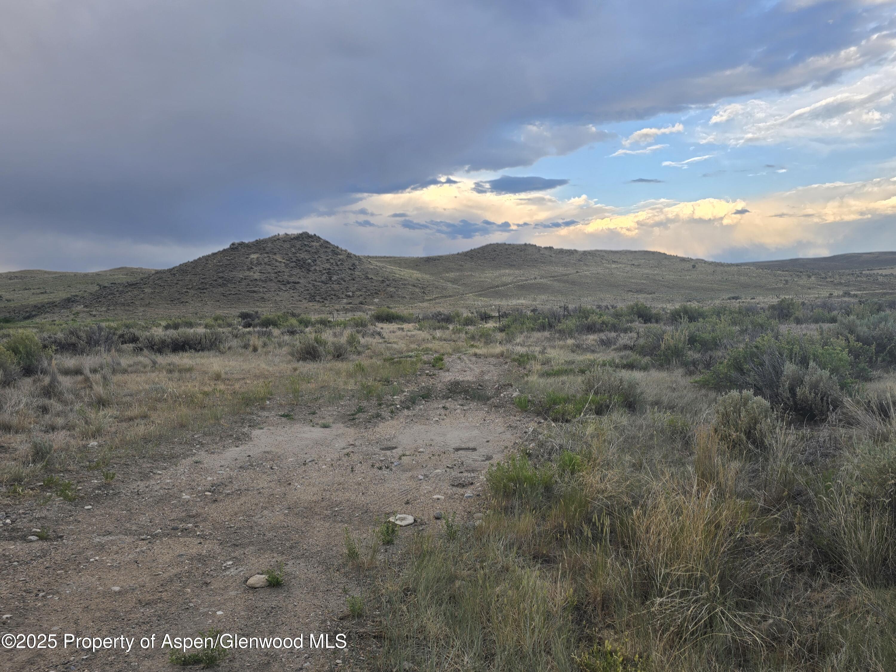 40 Highway 40 Craig, CO 81625 - Photo 11 of 46 a view of a dry yard with mountains in the background