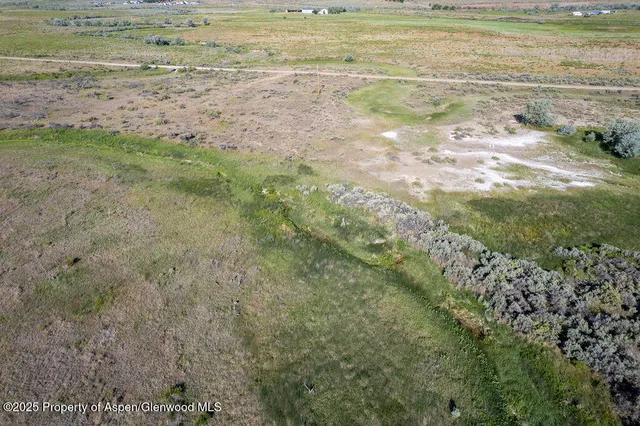 a view of a field with an ocean view