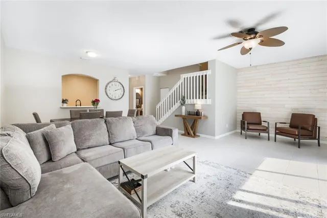 a living room with furniture and a lamp