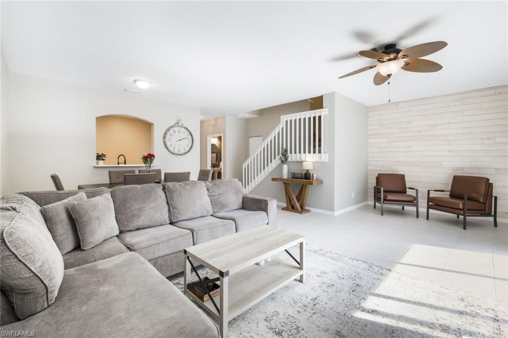 a living room with furniture and a lamp