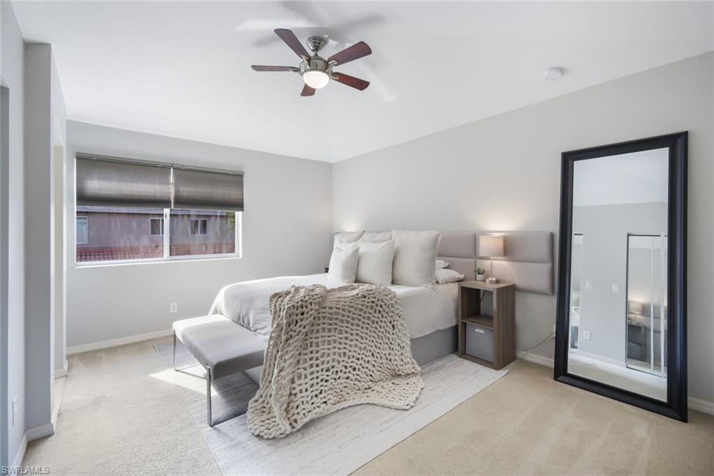 10004 Ravello Boulevard Fort Myers, FL 33905 - Photo 14 of 42 a spacious bedroom with a bed and a chandelier