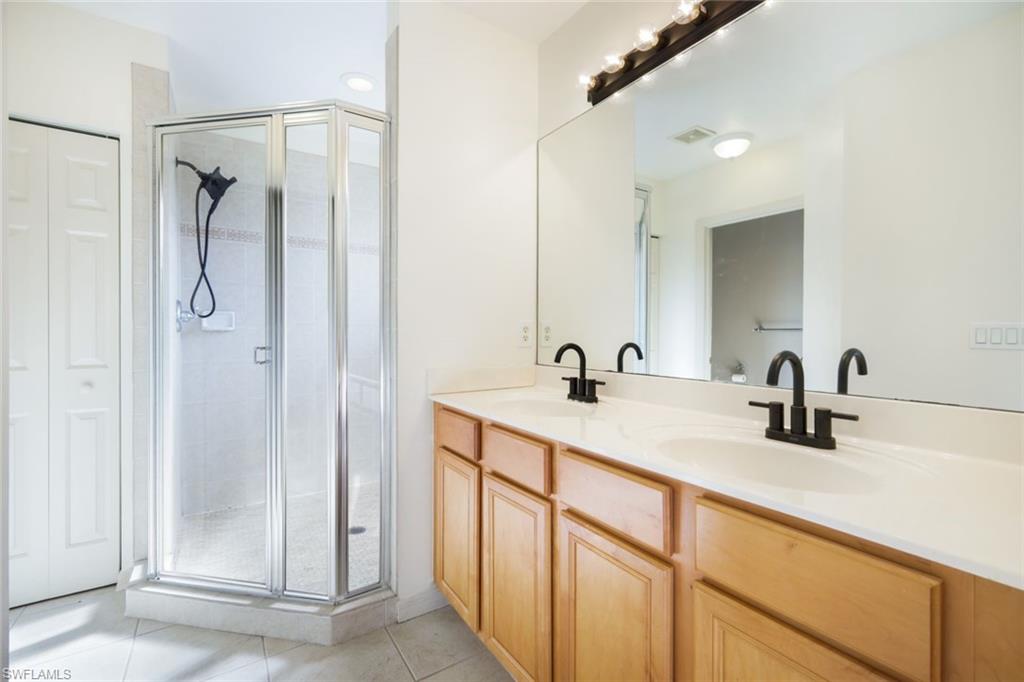 10004 Ravello Boulevard Fort Myers, FL 33905 - Photo 17 of 42 a bathroom with a double vanity sink mirror and shower