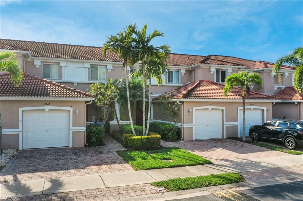 10004 Ravello Boulevard Fort Myers, FL 33905 - Photo 2 of 42 a front view of a house with garden