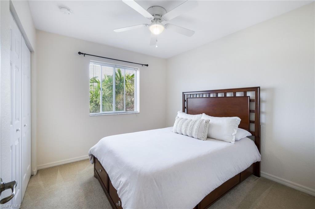 10004 Ravello Boulevard Fort Myers, FL 33905 - Photo 21 of 42 a bedroom with a bed and a chandelier