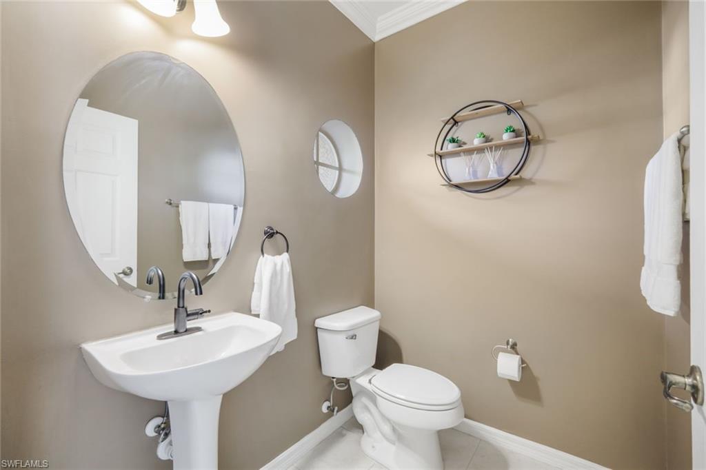 10004 Ravello Boulevard Fort Myers, FL 33905 - Photo 24 of 42 a bathroom with a toilet a sink and mirror