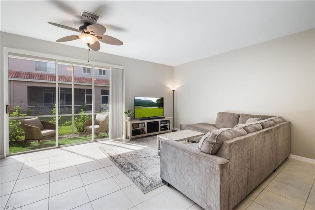 10004 Ravello Boulevard Fort Myers, FL 33905 - Photo 5 of 42 a living room with furniture and a flat screen tv