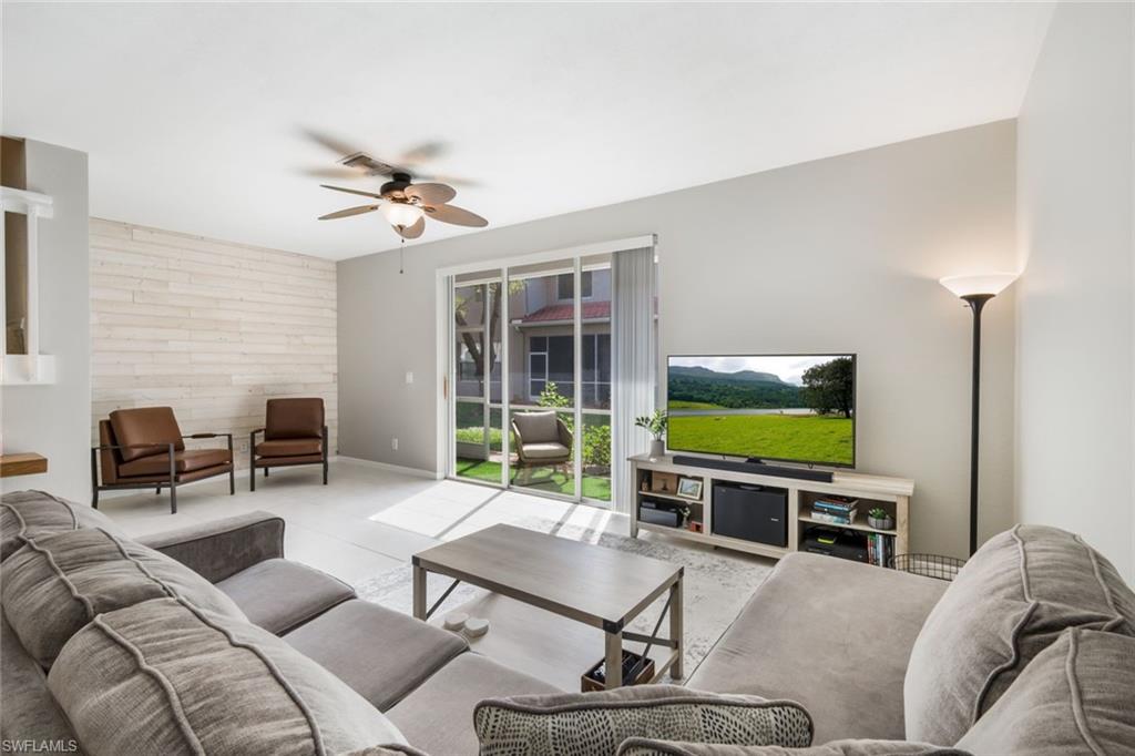10004 Ravello Boulevard Fort Myers, FL 33905 - Photo 6 of 42 a living room with furniture a ceiling fan and a flat screen tv