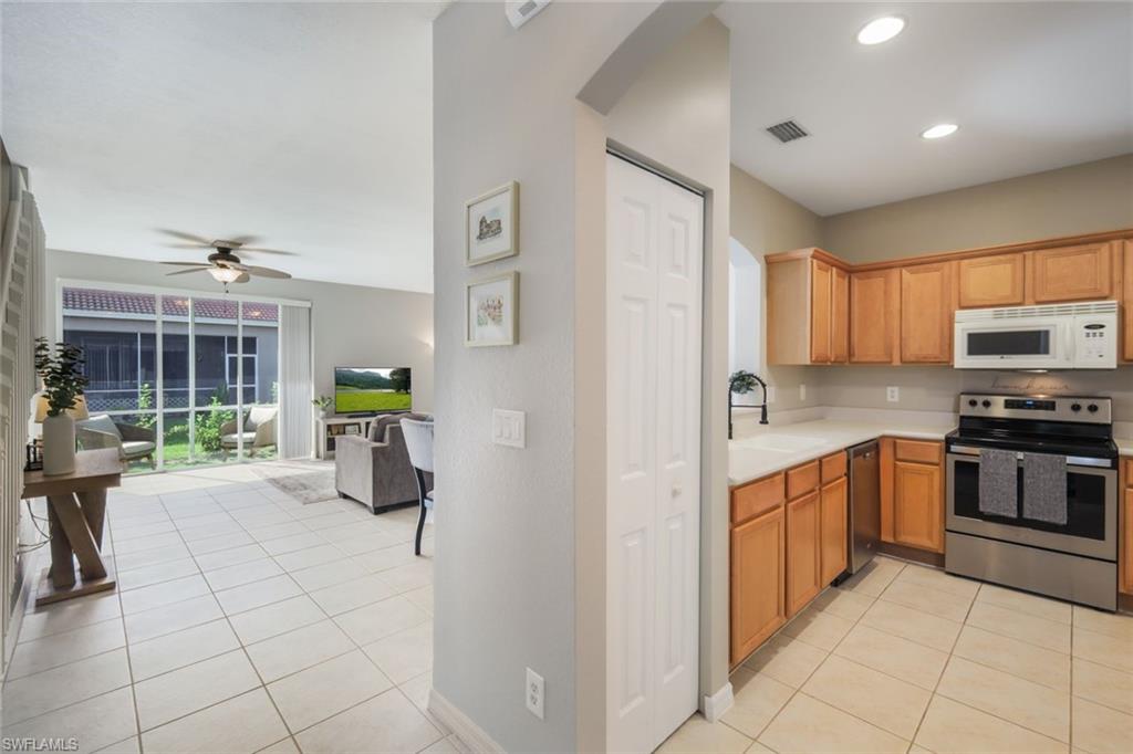 10004 Ravello Boulevard Fort Myers, FL 33905 - Photo 8 of 42 a kitchen with stainless steel appliances granite countertop a refrigerator and a stove top oven