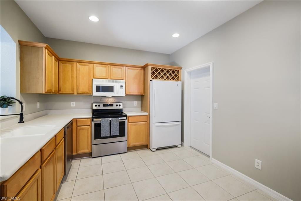 10004 Ravello Boulevard Fort Myers, FL 33905 - Photo 10 of 42 a kitchen with stainless steel appliances granite countertop a stove a sink and a refrigerator