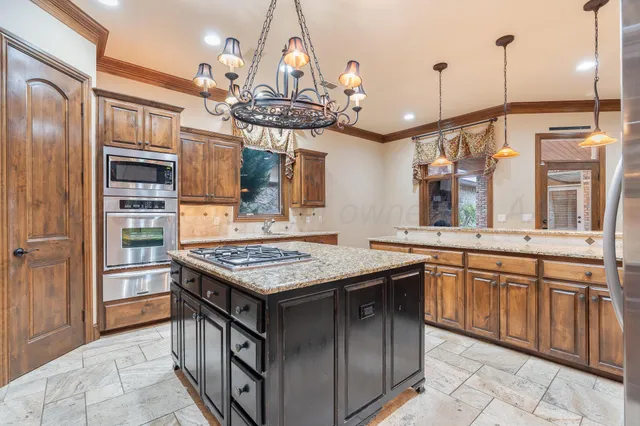 a kitchen with a counter space a sink and appliances