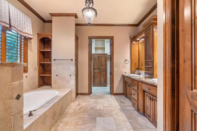 a bathroom with a tub sink and mirror