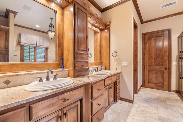 a bathroom with a granite countertop sink mirror and double