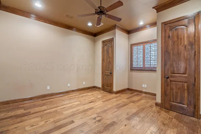 an empty room with closet and windows