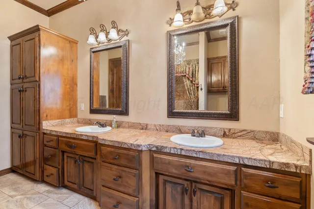 a bathroom with double sink and a mirror