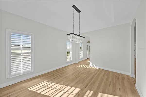 a view of a livingroom with a ceiling fan and wooden floor
