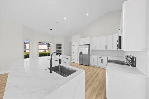 a view of a kitchen with wooden floor and a kitchen