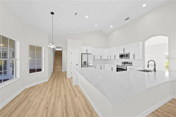 a bathroom with a bathtub shower sink vanity and toilet