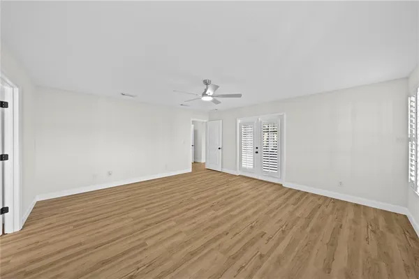 a view of an empty room and floor to ceiling window