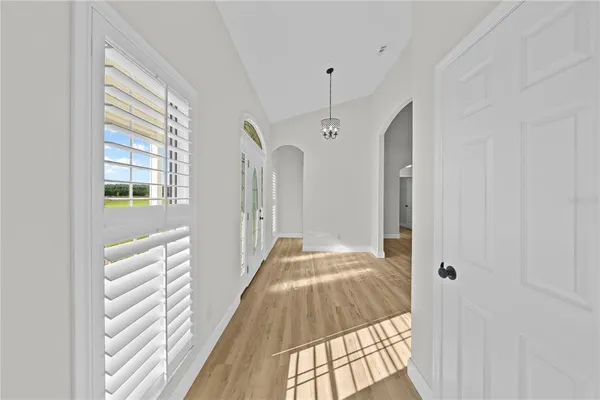 a kitchen with stainless steel appliances kitchen island a sink a stove and white cabinets