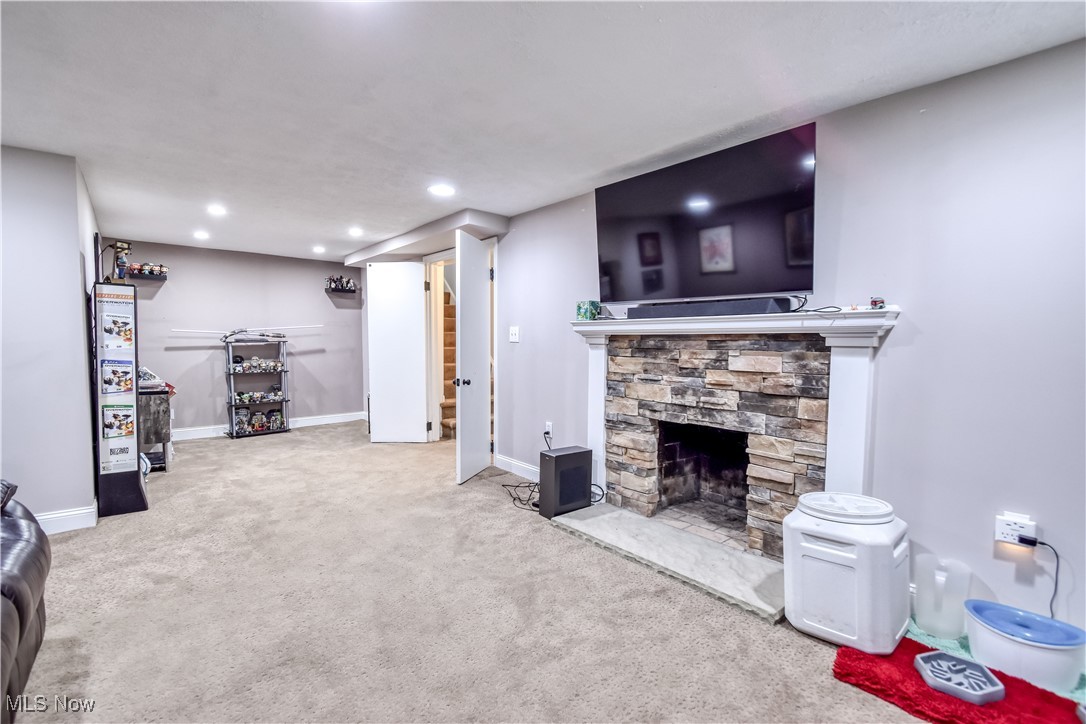 8115 Stockbridge Road Mentor, OH 44060 - Photo 39 of 46 Living room featuring carpet floors, a stone fireplace, and recessed lighting