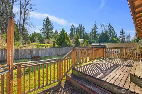 a view of balcony with wooden floor and fence