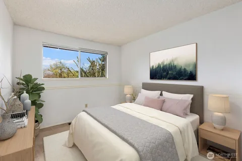 a bedroom with a bed and a painting on the wall