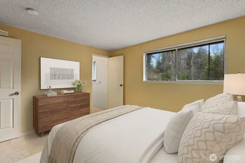 a bedroom with a large bed and a window