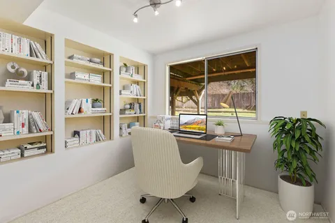 a dining room with furniture and a potted plant