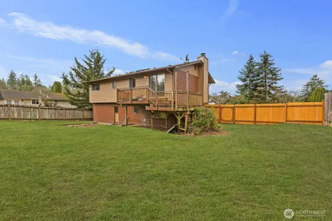 a backyard of a house with table and chairs